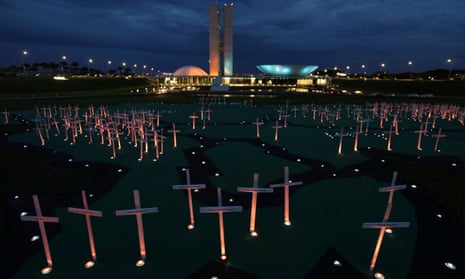 Crosses depicting people murdered for defending the forest stand on a large map of the Amazon, during a protest against the illegal timber trade, in front of the Brazilian National Congress building, in Brasilia, Brazil, 21 November 2017