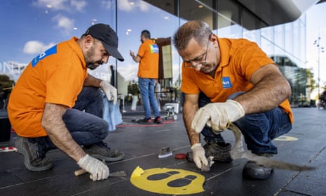 Employees remove Covid-19 social distancing safety stickers for the Stedelijk Museum in Amsterdam in The Netherlands as the 1.5 metre rule has ended.