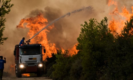 Emergency services try to extinguish a wildfire in northern Athens, Greece
