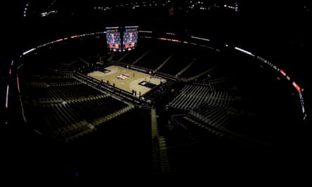 Big 12 commissioner Bob Bowlsby is seen on the big screen in an empty Sprint Center as he talks to the media after canceling the remaining NCAA college basketball games in the Big 12 Conference tournament due to concerns about the coronavirus onn 12 March 2020 in Kansas City, Missouri.