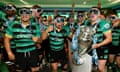 Northampton Saints wearing ski goggles celebrate in the dressing room with the Gallagher Premiership Rugby Trophy after their team's victory in the Final