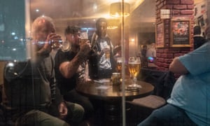 Men drinking beer in pub