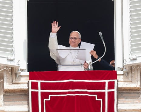 Pope Leo waves as he leads Sunday’s Regina Caeli prayer from the window of his office overlooking Saint Peter’s Square in Vatican City