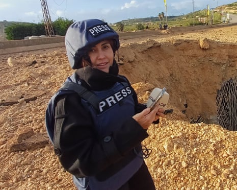 Lebanese journalist Amal Khalil of the daily Al-Akhbar newspaper reports near a destroyed bridge in Qasmiyeh, Lebanon, last month
