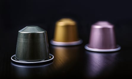 Close-Up Of Coffee Capsules On Table Against Black Background