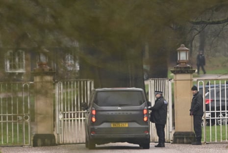 A police officer inspects a vehicle outside the gates of Royal Lodge.