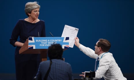 Theresa May is handed a fake P45 by the comedian Simon Brodkin during her speech at the Conservative party conference.