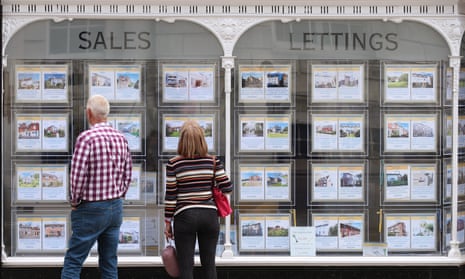 People looking at house price signs