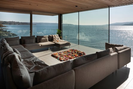 Floor-to-ceiling windows in the living room look out over the loch