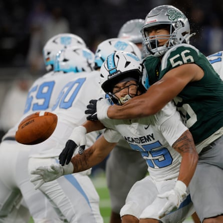 NFL Academy player Isaac Fullah from Oxford drops the ball as he gets clattered by Matthew Johnson of De La Salle.