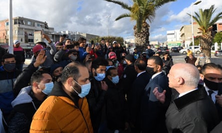 Tunisian President Kais Saied, right, calls for calm in Tunis, 18 January 2021.