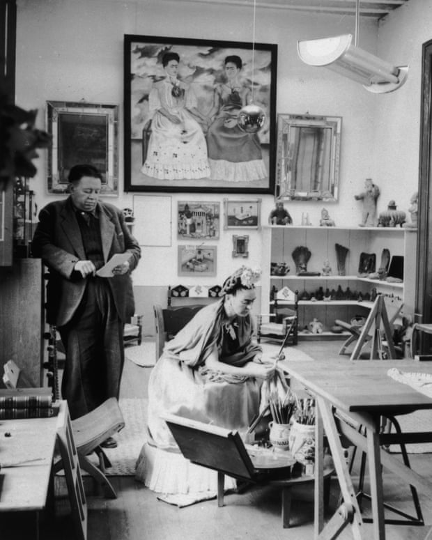 Diego Rivera and Frida Kahlo. Kahlo’s self-portrait, The Two Fridas (1939), hangs in the background.