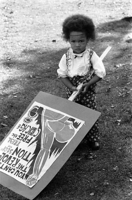 A girl holds a placard