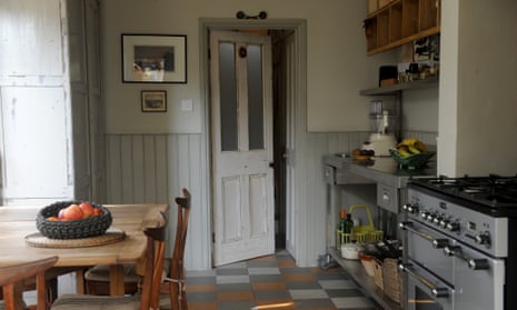 a victorian kitchen space with secondhand wood and stainless furniture and appliances