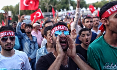 Supporters of Turkish president Recep Erdoğan chant slogans and wave Turkish flags as they gather in Istanbul’s main Taksim Square. 