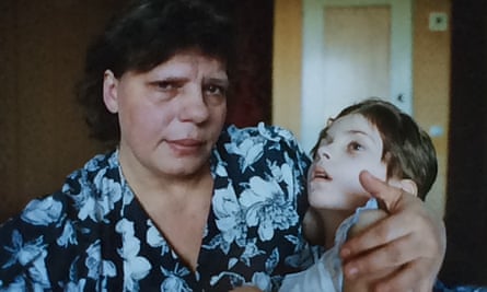 Oksana is held by a family member.