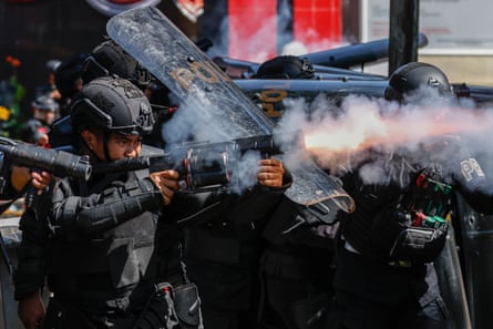 Police officers fire teargas