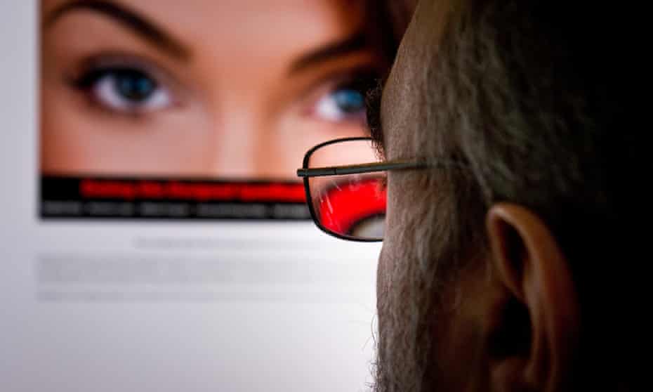A man looking at an attractive woman on an internet dating site.