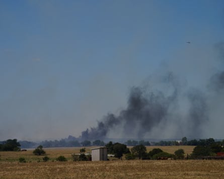 Smoke billows from the scene of the crash.