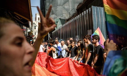 Turkish riot police officers fire rubber bullets at demonstrators during an LGBT rally on Istiklal Avenue, Istanbul