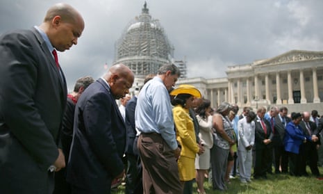 Members of the US Congress during a prayer circle on 18 June 2015 in front of the US Capitol to honour those gunned down last night inside a Charleston church.