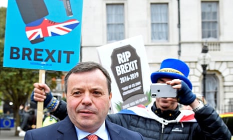 British businessman and co-founder of the Leave.EU campaign, Arron Banks walks past anti-Brexit demonstrators outside the Houses of Parliament in  2019. 