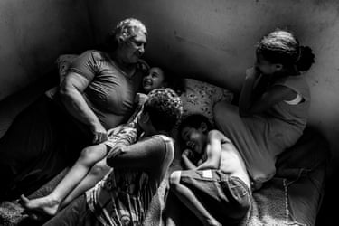 Black and white image of Sandra Mara Siqueira resting with her grandchildren, Micael, Davi, Ana Flávia and Vitória