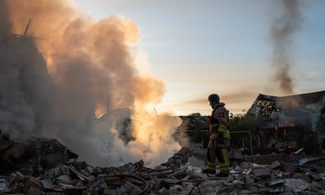 Rescuers extinguish the fire at the site of a Russian missile strike.