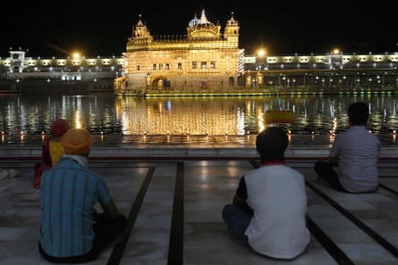 Sikh devotees pay respect on the occasion of the 399th birth anniversary of the ninth Sikh Guru, Teg Bahadur, at the illuminated Golden Temple