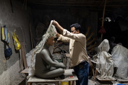 Man lifts the cover on a lifesize model of a man