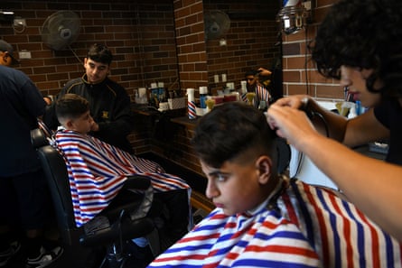 Students cutting hair in the barbershop program.
