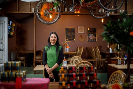 She stands in the pink-walled dining room, surrounded by tables