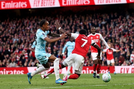 Bukayo Saka of Arsenal is challenged by Lucas Pires of Burnley in the penalty area.