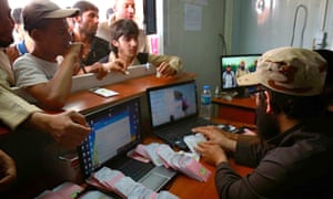 Mosul residents queue to receive authorised CDs from Islamic State members in a photograph from a militant website.