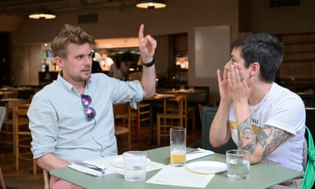 Two people sitting talking at a restaurant table