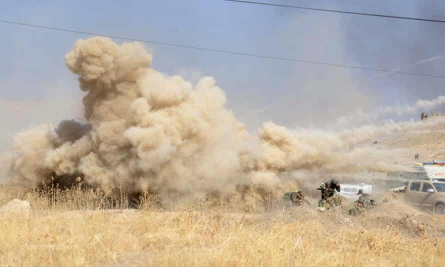 Smoke rises after a suicide bomb attack against Kurdish forces near Mosul.