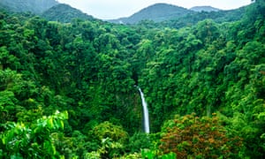 A distant shot of the waterfall of La Fortuna in the verdant Arenal Volcano National Park, Costa Rica,