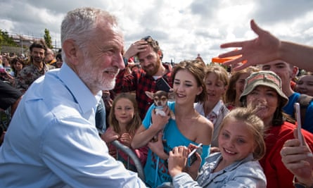 Corbyn talks to supporters at the end of a rally at Heartlands