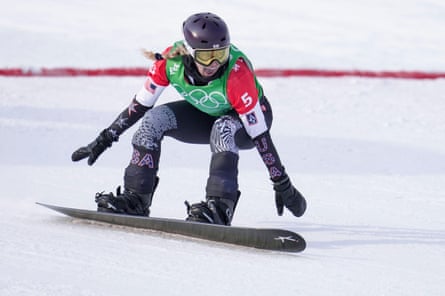 Lindsey Jacobellis crosses the finish line to win the women’s snowboard cross final at the Beijing 2022 Winter Olympics.
