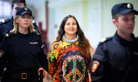 Sasha Skochilenko is escorted by officers to a courtroom in St Petersburg, Russia.