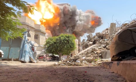 Smoke and flames rise from a house hit by an Israeli strike, amid the ongoing conflict between Israel and Hamas, in Nuseirat refugee camp, in the central Gaza Strip, in this still picture taken from a video August 27, 2024.