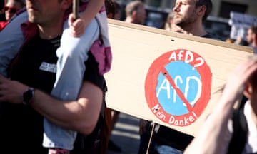 A person in a crowd holds a sign reading 'AfD? No thank you'