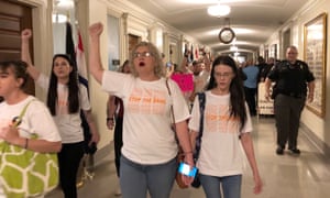 Protesters march through the halls of the Missouri capitol outside the house chamber on Friday in Jefferson City in opposition to legislation prohibiting abortions at eight weeks of pregnancy.