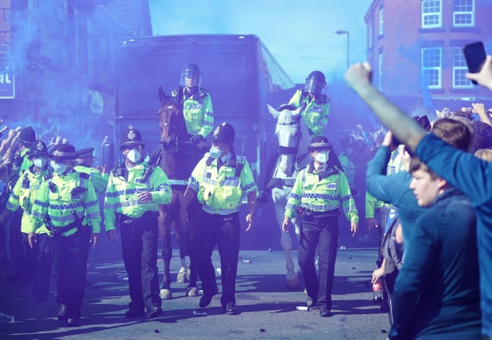 Police escort the Everton team bus into Goodison Park.