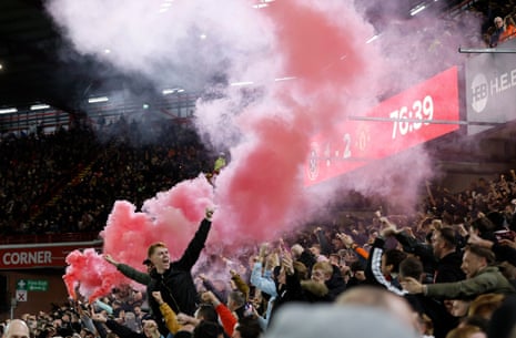 21 October 2023A flare is set off as Manchester United’s fans celebrate their side’s second goal of the game against Sheffield United at Bramall Lane.