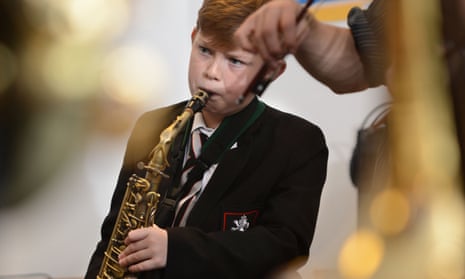 A schoolboy playing a saxophone