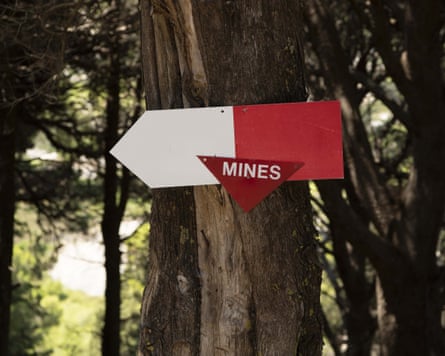 A sign warning of mines on a tree on Sazan Island, Albania.