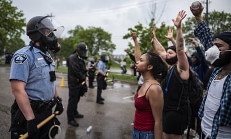 Protesters and police face each other during a rally for George Floyd in Minneapolis on Tuesday, May 26, 2020. Four Minneapolis officers involved in the arrest of the black man who died in police custody were fired Tuesday, hours after a bystander’s video showed an officer kneeling on the handcuffed man’s neck, even after he pleaded that he could not breathe and stopped moving. (Richard Tsong-Taatarii/Star Tribune via AP)