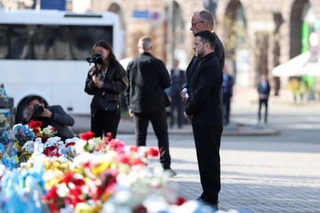 Merz and Zelenskyy pay tribute at the makeshift memorial to fallen Ukrainian defenders at the Independence Square in Kyiv, Ukraine, October 4, 2026. REUTERS/Alina Smutko