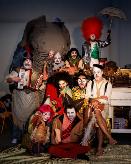 A group of nine clowns in various costumes